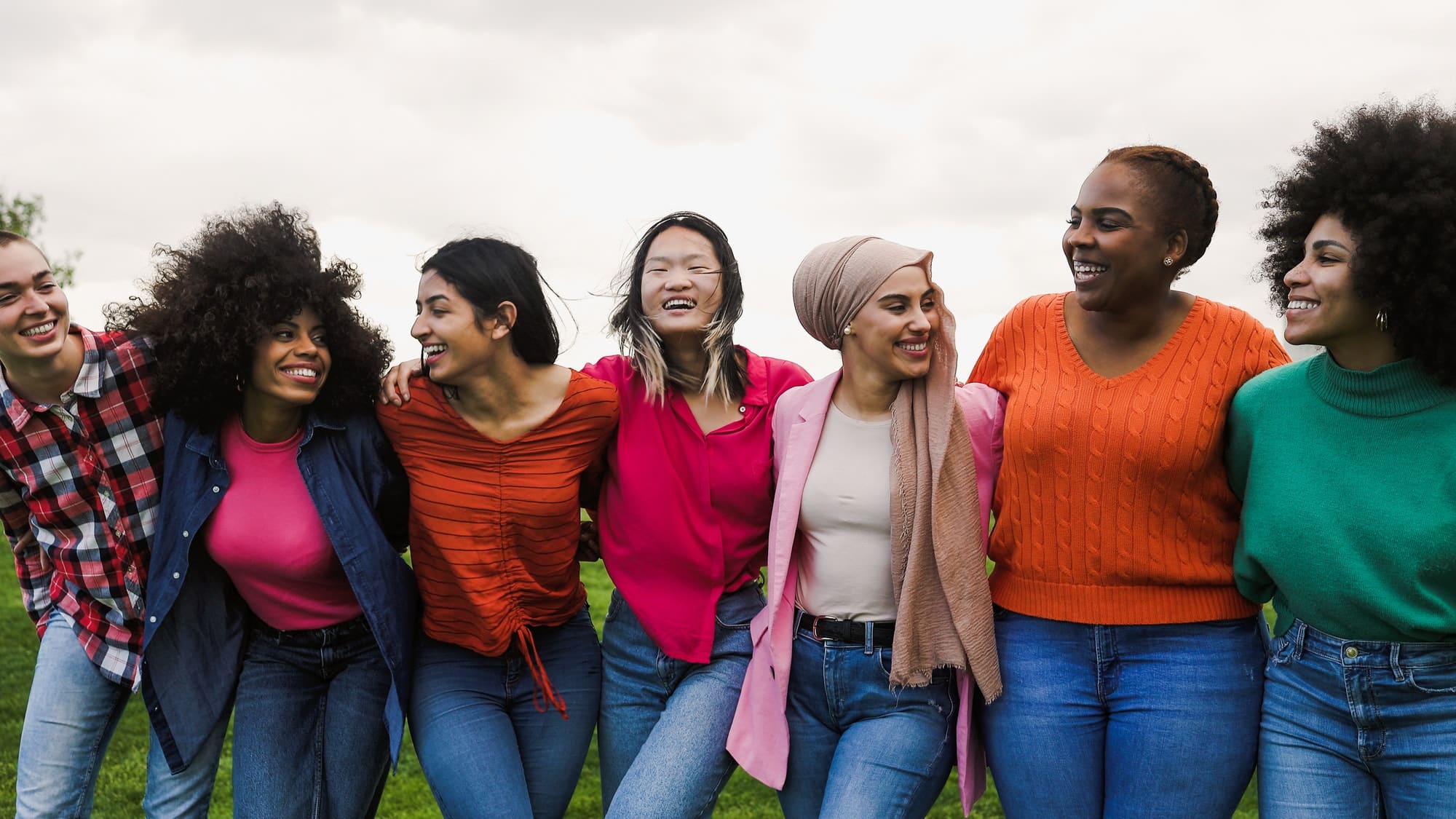 Happy young multi ethnic women having fun in a park - Diversity and friendship concept